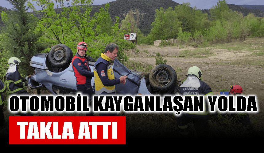 Otomobil yağmur nedeniyle kayganlaşan yolda takla attı